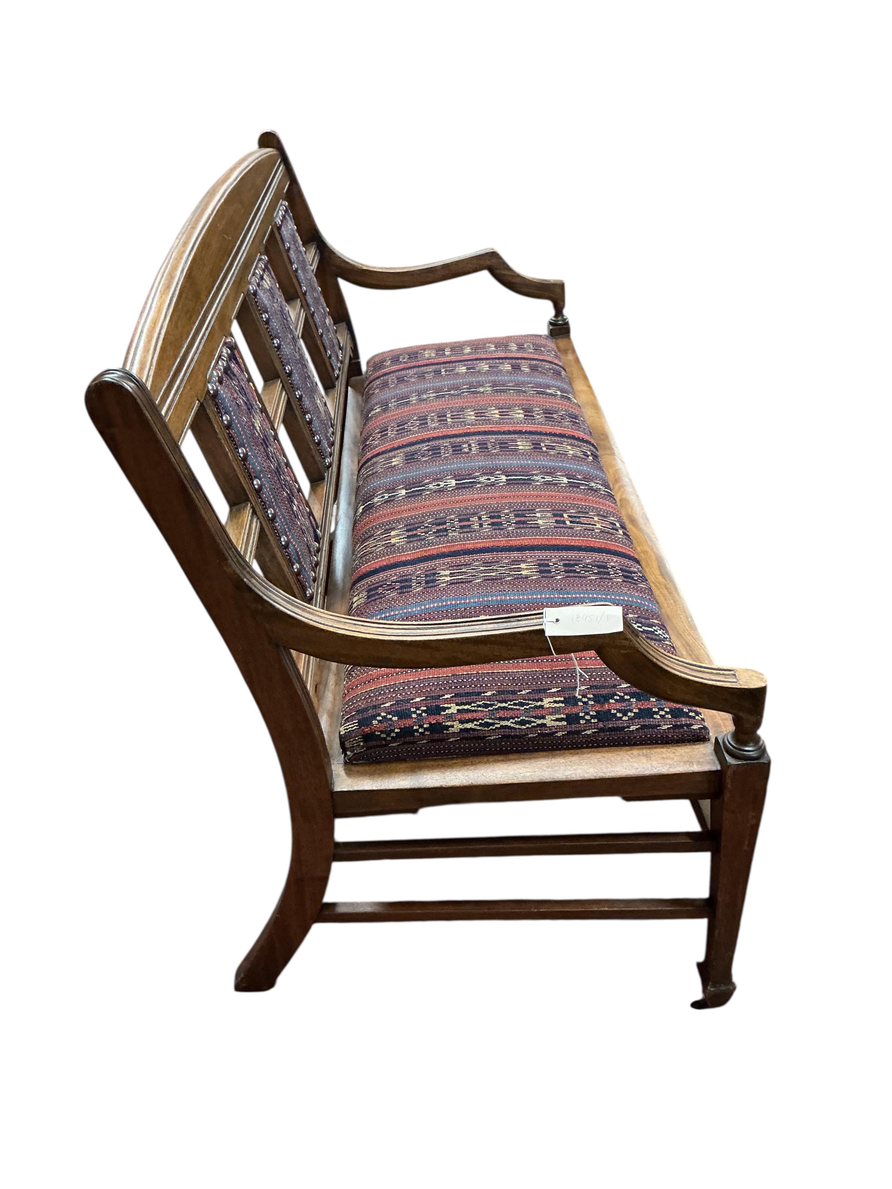 A late Victorian Aesthetic period walnut bench / settee, width 138cm, depth 50cm, height 80cm